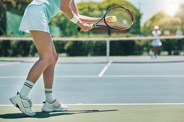 Tennis serve, sports and woman with legs on outdoor court, fitness motivation and competition with .